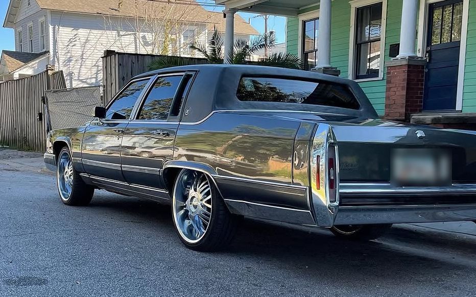 Gray Cadillac Brougham on chrome wheels