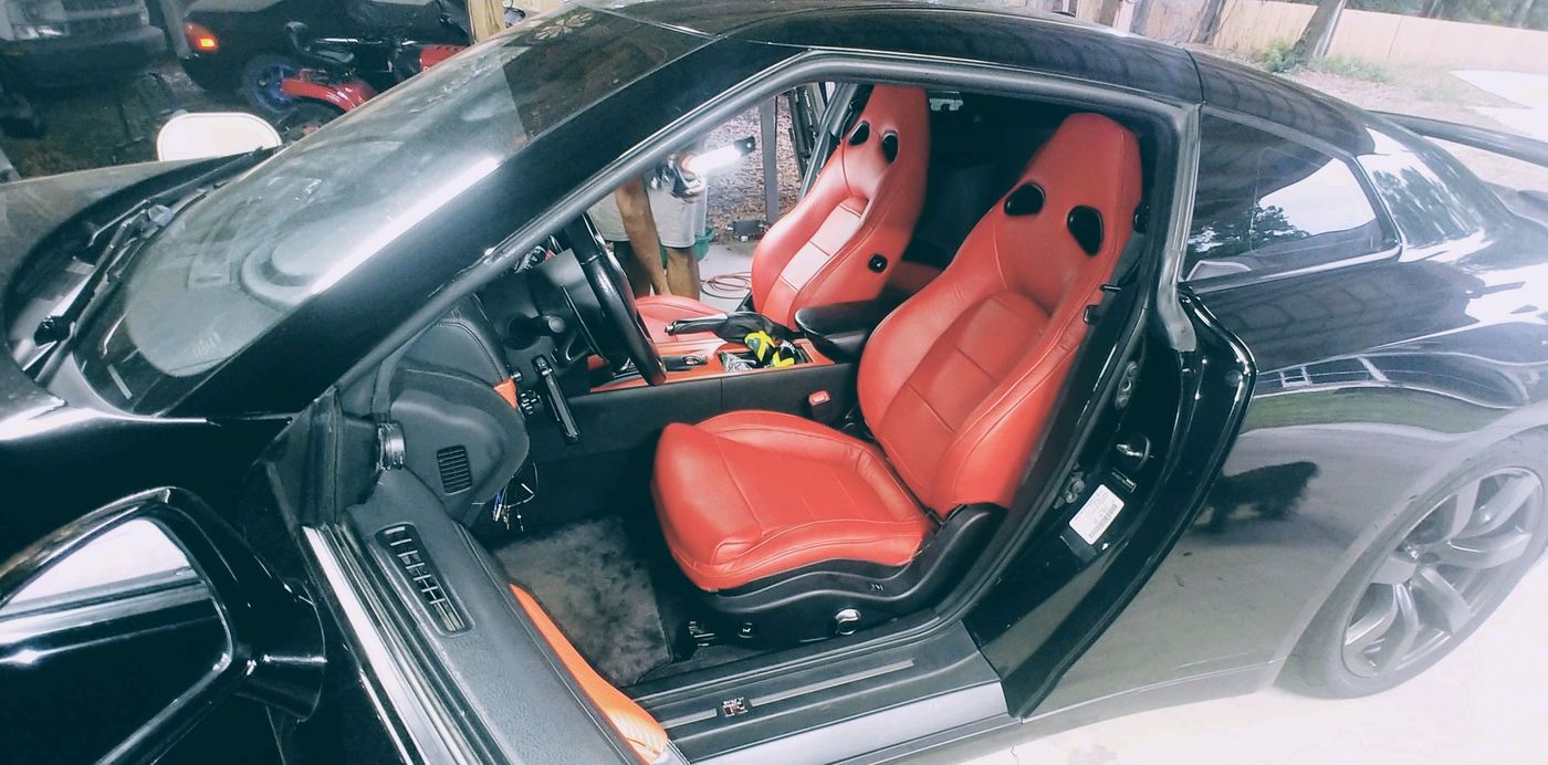Red leather sport seats in a black coupe