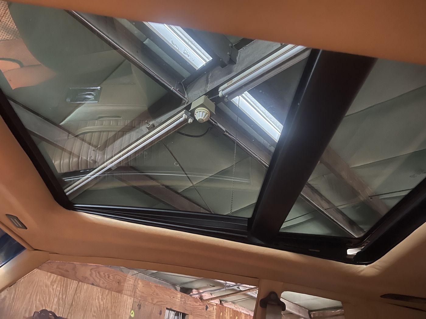 Tan suede headliner around a sunroof