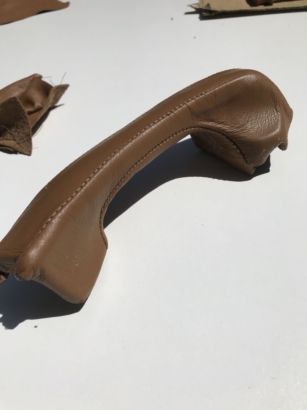 Grab handle being wrapped in brown leather