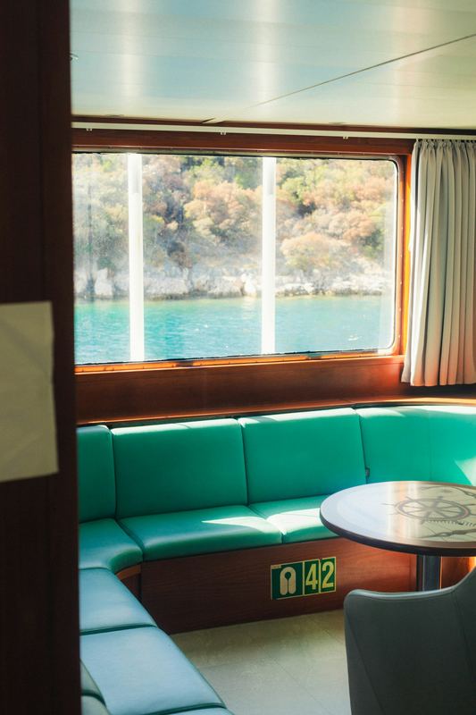 Teal upholstered bench in a boat cabin